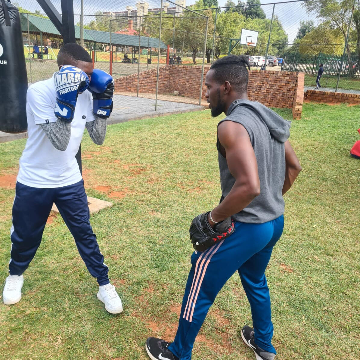 Famous personal trainer and professional boxer in Johannesburg South at a school helping children with their boxing skills